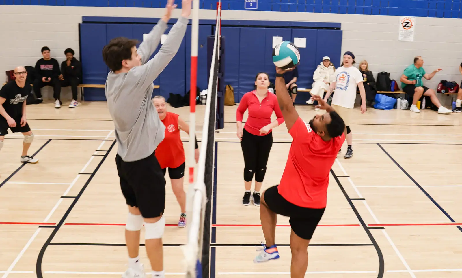 Volleyball players preparing to serve and receive